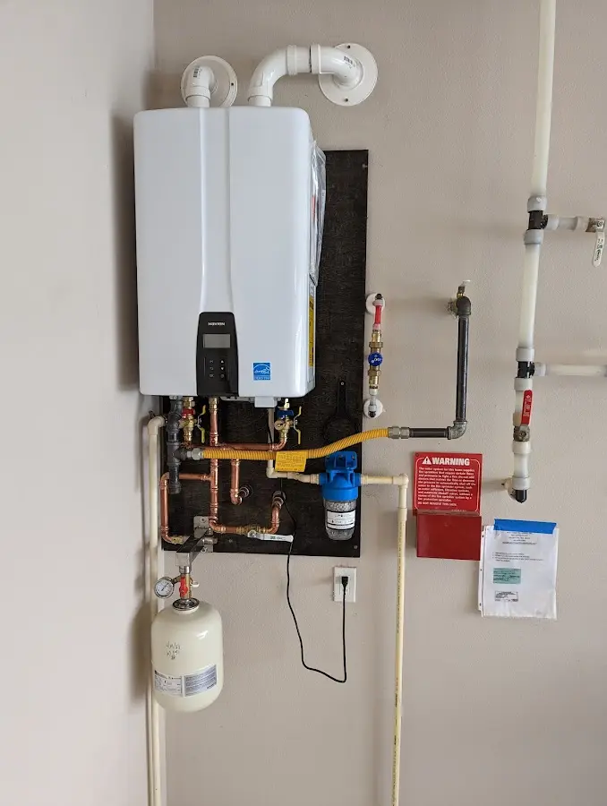 Professional plumber installing copper piping in a Montague home